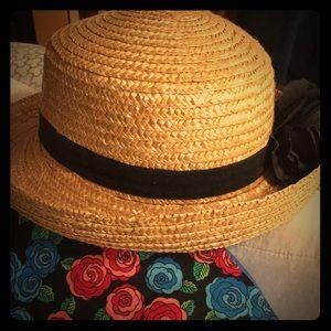 Straw hat with black band and black flower